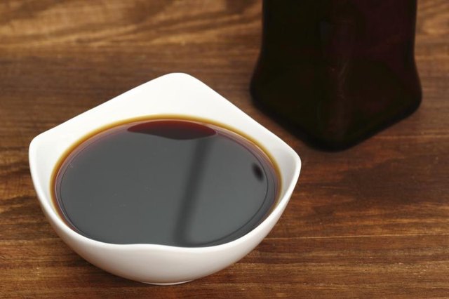 A bowl filled with soy sauce.