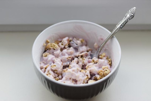 A bowl of flavored fruit yogurt with crunchy granola.