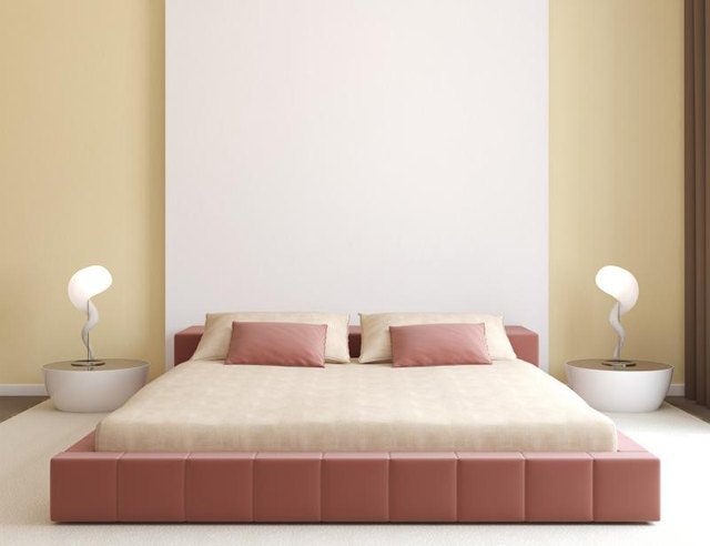 A minimalist style contemporary bedroom with a pink and beige color scheme.