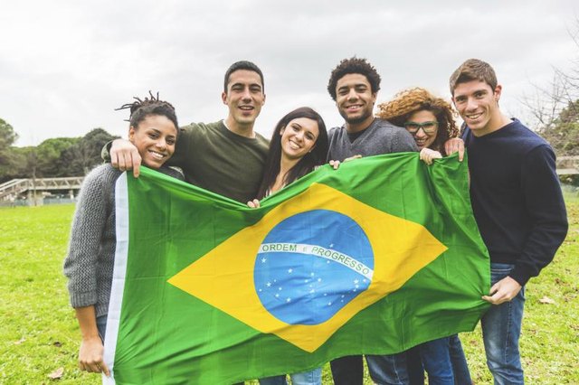 University students holding a Brazilian flag.