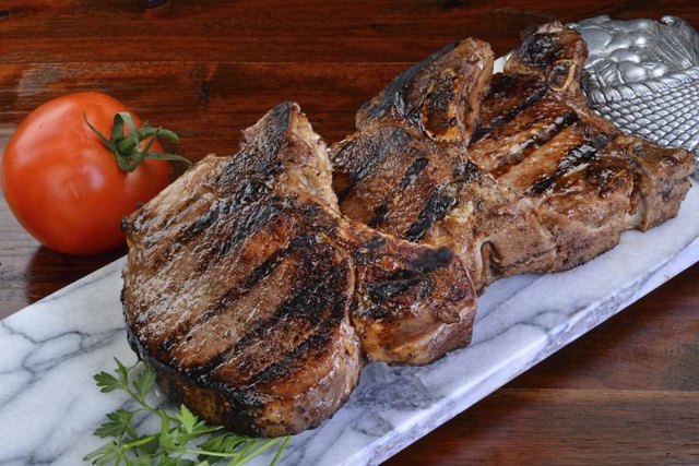 Grilled pork chops on stone cutting board