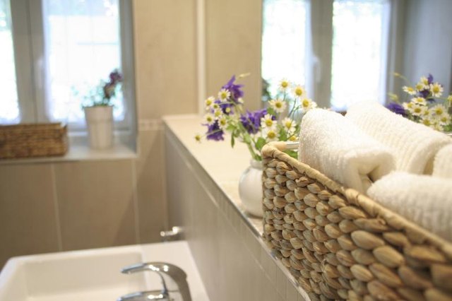 A basket of folded towels in a clutter-free bathroom.