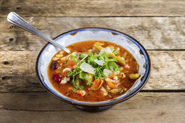 Minestrone soup in a bowl with spoon.