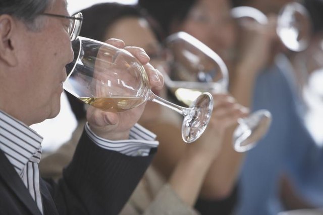 Group of seniors drinking white wine.
