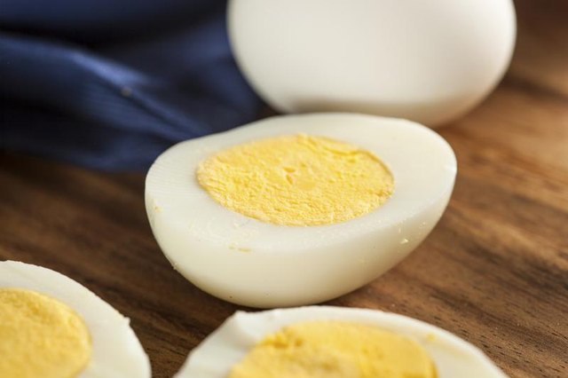 Halved hard boiled eggs on countertop.