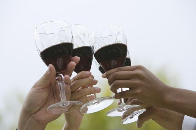 Friends toasting with red wine glasses
