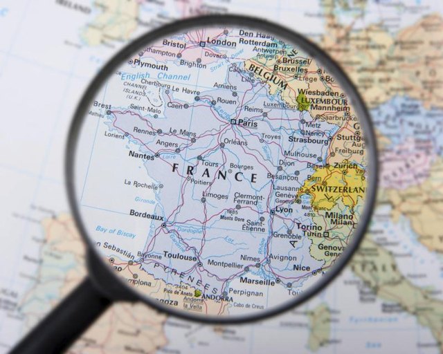 Magnifying glass enlarging France.