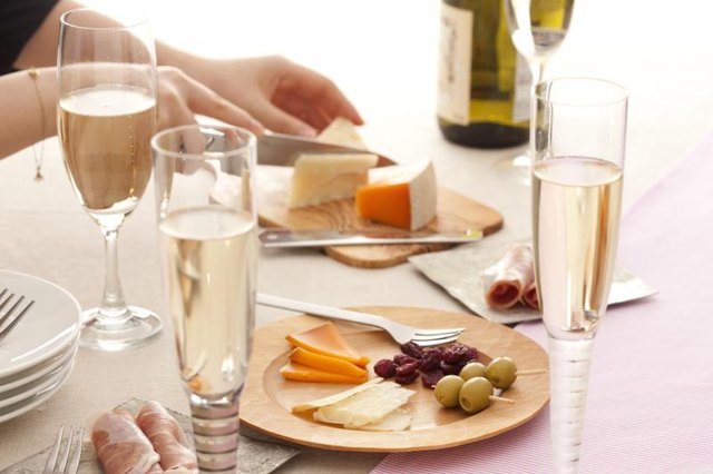 Someone is slicing cheese on a nice table.