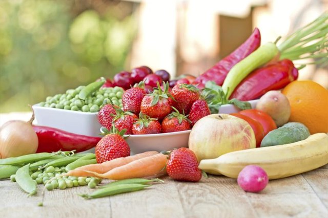 Fresh fruits and vegetables on an outdoor table.