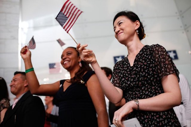 Patriots waving flags at a ceremony.