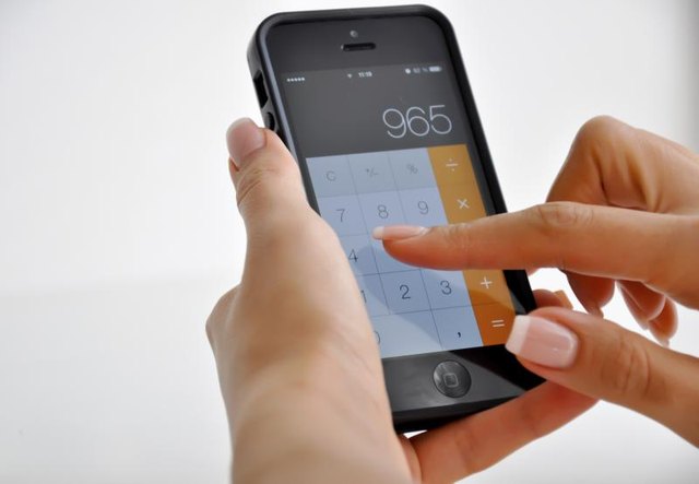 A woman doing math on her iPhone