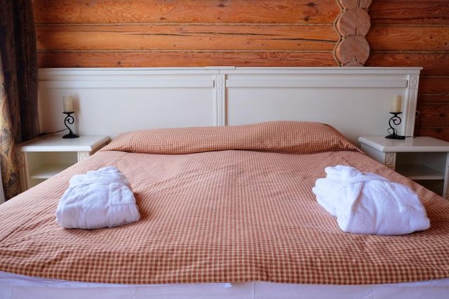 Captians bed with spa robes on edge.