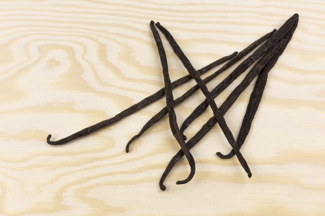 Dried vanilla pods on wooden board