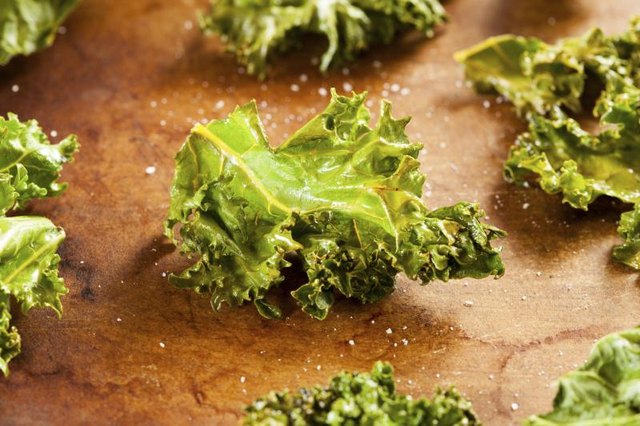 A close-up of Kale chips with sea salt.