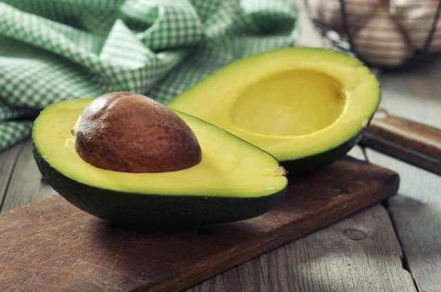 Sliced avocado on cutting board. Sliced avocado on cutting board.
