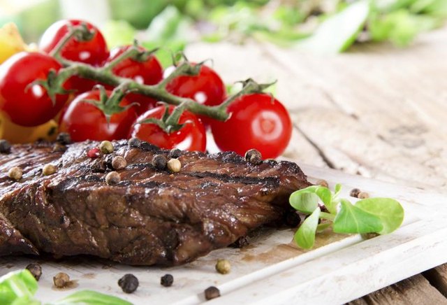 Grilled sirloin steak on cutting board.