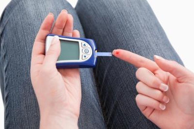 A woman tests her blood sugar.