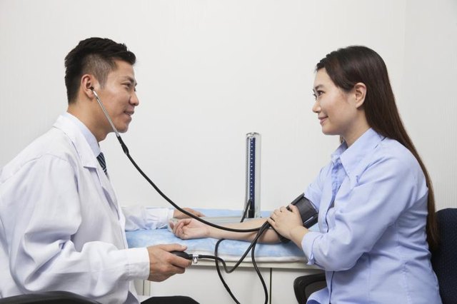 Woman having her blood pressure tested.