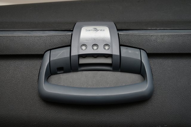 How do you reset a Samsonite luggage combination lock?