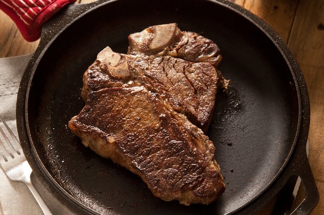 Grilled steak in a cast-iron skillet. Grilled steak in a cast-iron skillet.