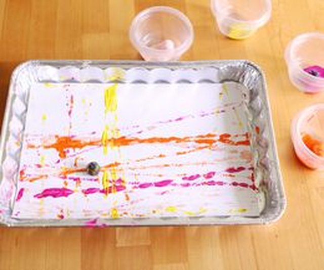 Create mess-free abstract prints using marbles. Create mess-free abstract prints using marbles.