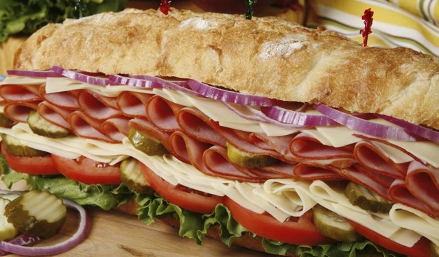 An overstuffed ham and cheese submarine sandwich An overstuffed ham and cheese submarine sandwich