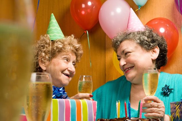 Senior citizens drinking champagne at a party. Senior citizens drinking champagne at a party.