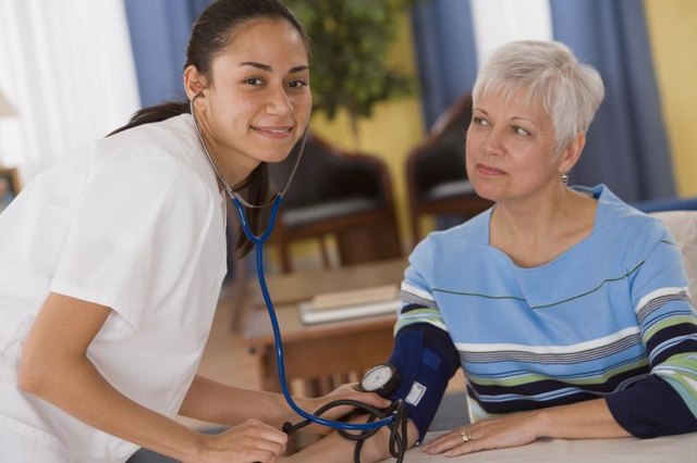 Nurse checking a mature woman's blood pressure. Nurse checking a mature woman's blood pressure.