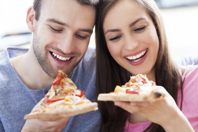 Couple eating pizza Couple eating pizza