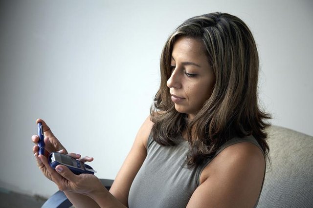 A diabetic taking a blood sugar test. A diabetic taking a blood sugar test.