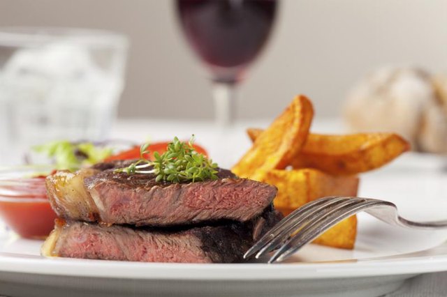 Cose-up of steak on plate at restaurant. Cose-up of steak on plate at restaurant.