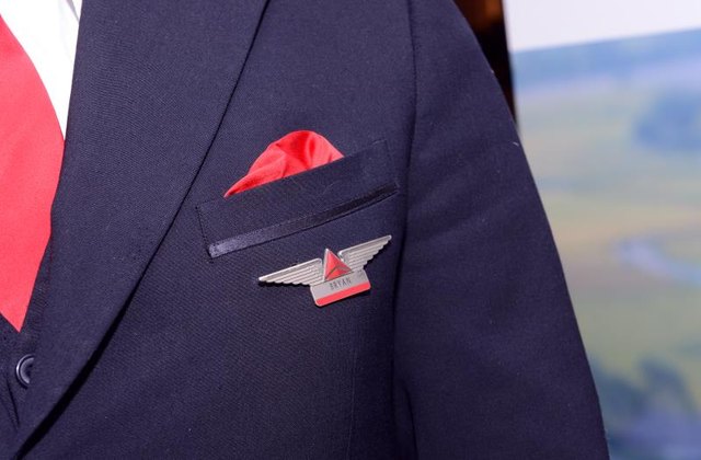 Detail of a Delta Airlines flight attendant coat with insignia Detail of a Delta Airlines flight attendant coat with insignia