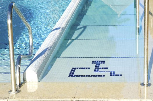 A handicapped ramp at a swimming pool. A handicapped ramp at a swimming pool.