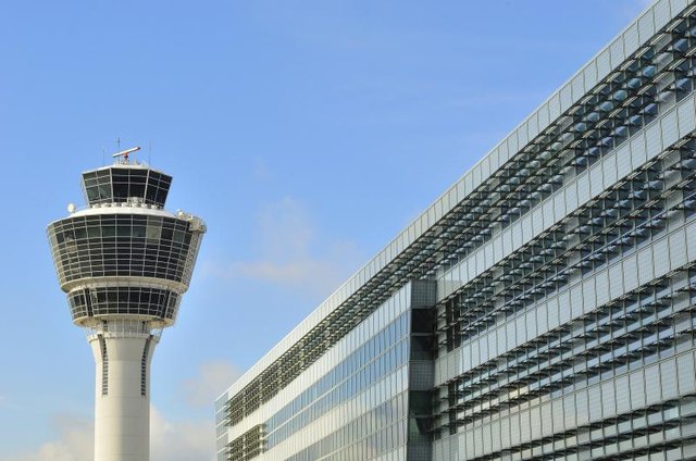 An air traffic control tower at an airport. An air traffic control tower at an airport.