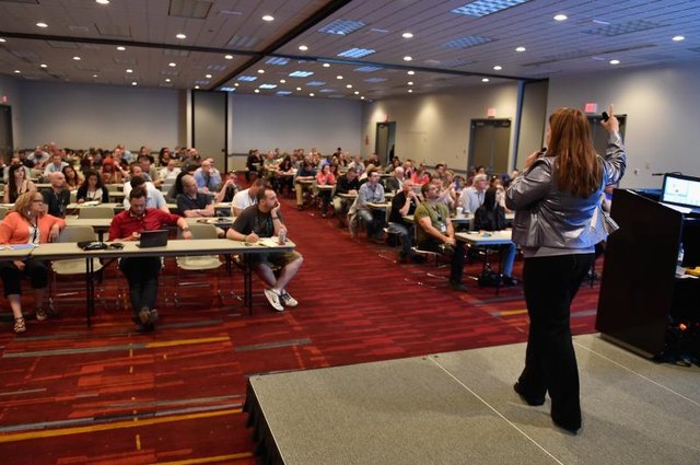 A marketing coordinator presenting a product or service at a conference. A marketing coordinator presenting a product or service at a conference.