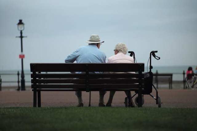 Senior citizens relax on bench Senior citizens relax on bench