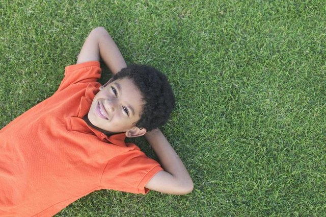 Boy lying on grass Boy lying on grass