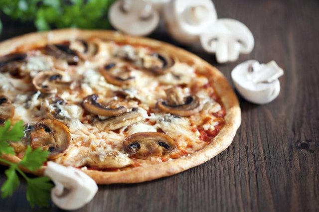 Mushroom pizza on a table. Mushroom pizza on a table.