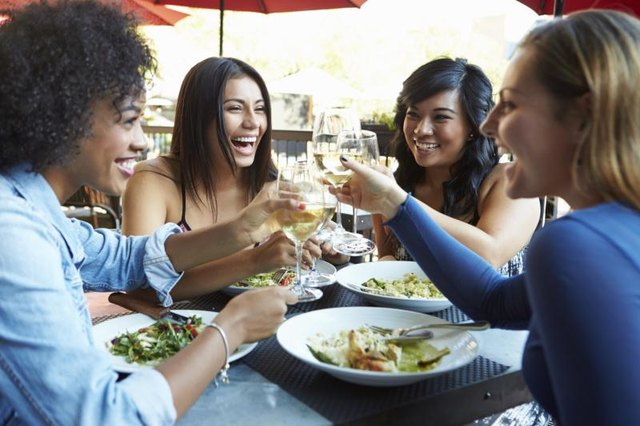 Women toasting at restaurant. Women toasting at restaurant.