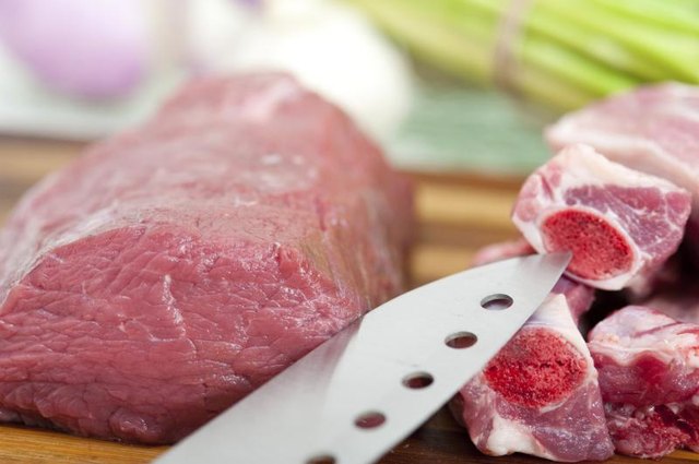 Beef being cut up with knife Beef being cut up with knife