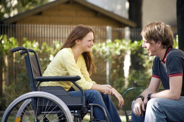 Young woman in wheelchair outdoors Young woman in wheelchair outdoors