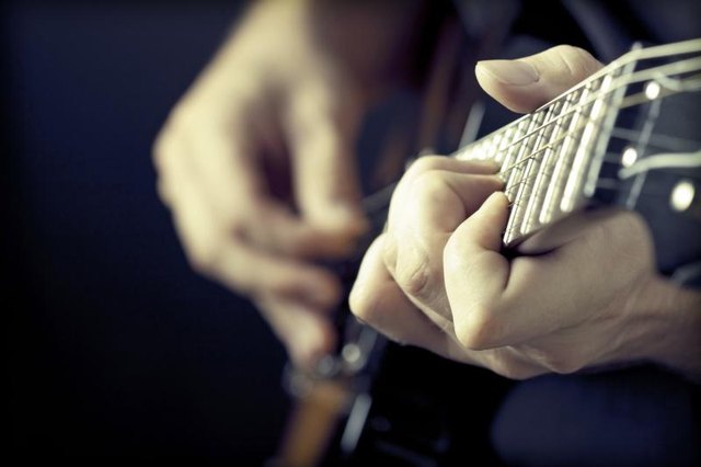 Hands playing a guitar. Hands playing a guitar.