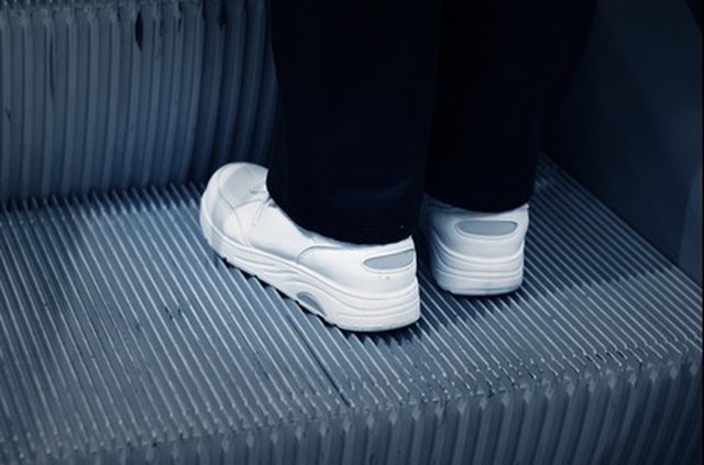 Scuff marks and dirt stand out on white shoes.