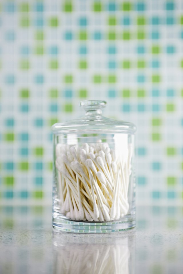 Cotton swabs in a glass container