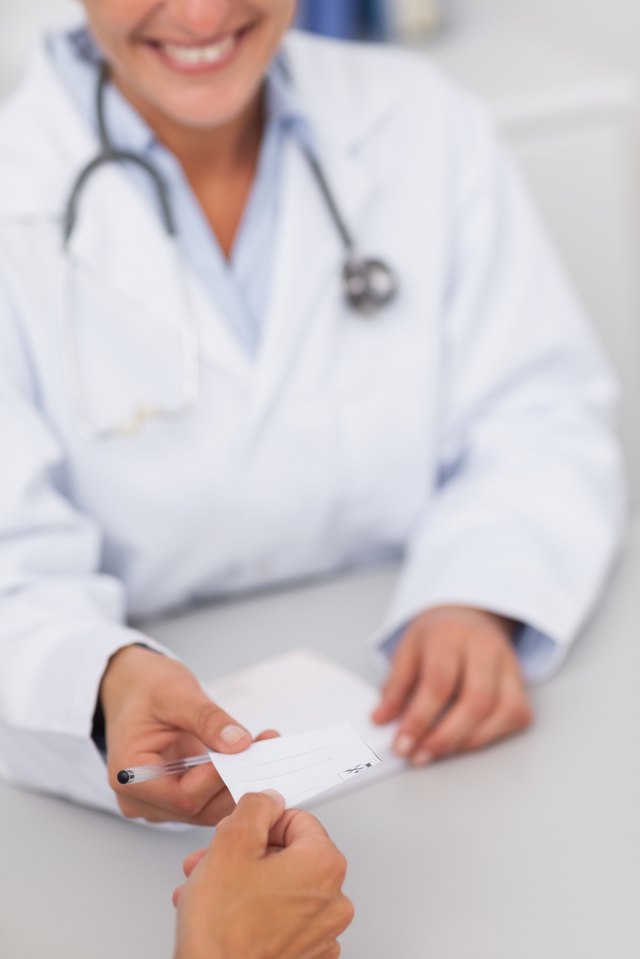 Doctor gives prescription to patient Doctor gives prescription to patient