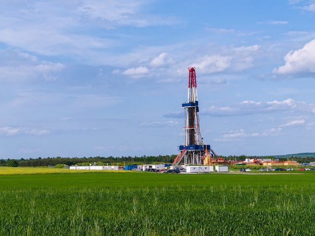 An oil shale drill is operating in a field.