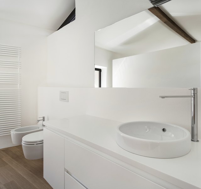 An all-white bathroom in a modern loft.