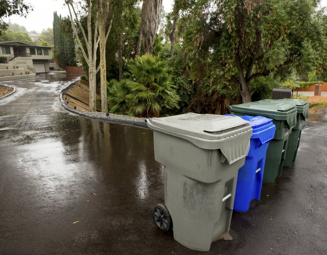 Compost and recycle bins on a suburban street.