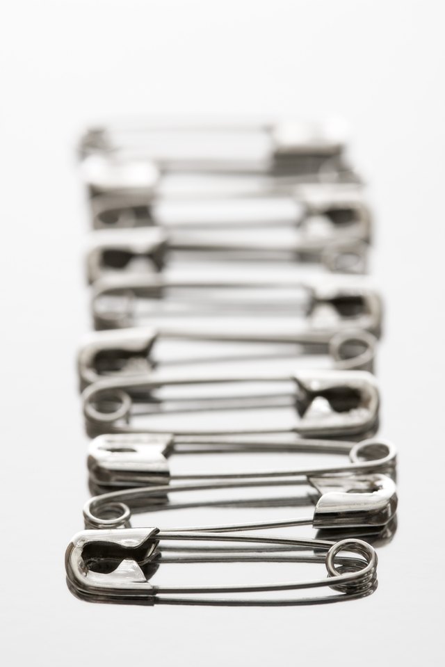 Safety pins can temporarily change the width and length of any sweater.