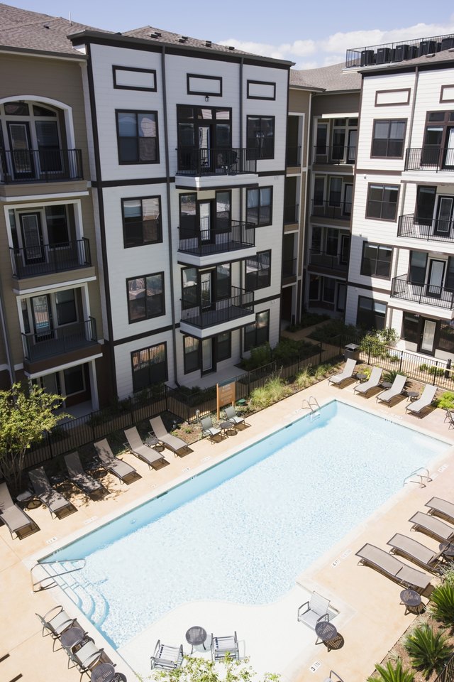 An apartment building with a swimming pool.